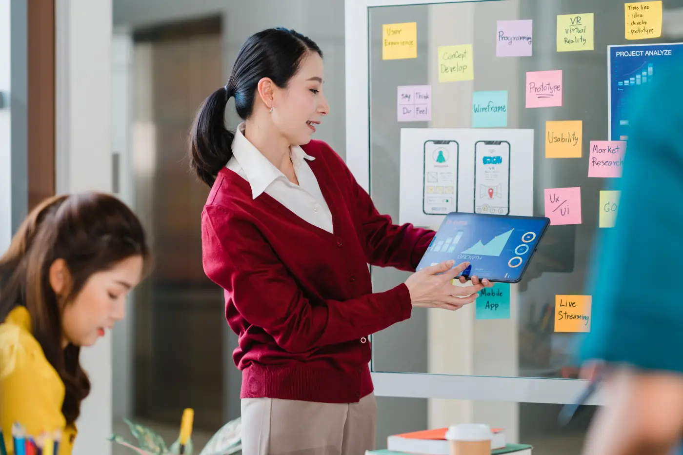 Creative team meeting and brainstorming ideas and conducting mobile application software design project with colleagues in modern office coworker teamwork concept